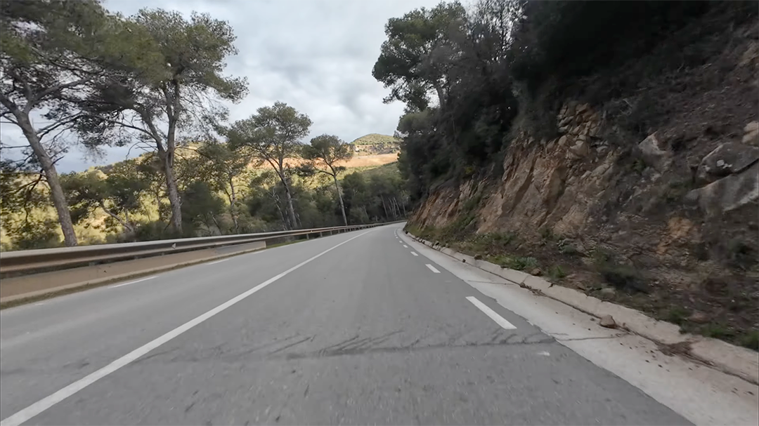 Video frame at 22m22s - Mountain road cycling scene
